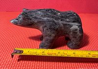 Soapstone bear sculpture with measuring tape showing length approx 5.5 inches.