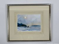 Framed watercolour painting showing "The Lone Loon" scene with lake, loon, sun, and distant trees.