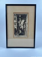 Framed and matted etching visible on white background.