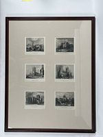 Framed piece with six small antique black and white engravings of cathedrals arranged in two columns and three rows within a dark wooden frame and wide beige matte