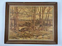 Framed vintage art print after A.Y. Jackson showing a springtime landscape scene with trees and rocky terrain, in a medium brown wooden frame with a gold liner.