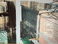 Close-up photo showing the detailed steel rebar construction elements and concrete with blueprint sketches in white overlay.