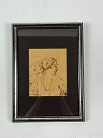 Framed original ink sketch of a young woman in profile with black mat and silver frame against white background.