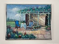 Frontal view of framed original acrylic painting showing detailed garden patio scene with chairs, table, trellis, flowers, and foliage.