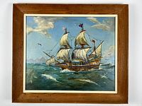 Framed oil painting showing a historic ship in ocean waves under blue skies with clouds and a bird, featuring sails and rigging, signed lower right.