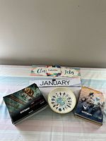 Lot overview showing Class Jobs calendar for January, circular children-and-globe poster, and two enVision Mathematics textbooks with illustrated animal covers.