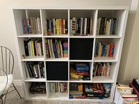 Front view of white 4x4 cube bookshelf showing all compartments
