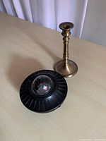 LED galaxy projector and gold candlestick on table