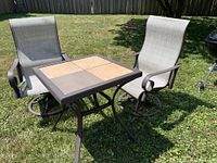 Table with both chairs on lawn