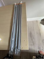 Full view of two packaged rods on table