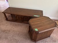 View of coffee table and octagonal side table showing dark brown laminate finish and wood grain pattern with storage doors.