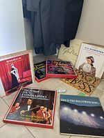 Several boxed vinyl record sets stacked together featuring classic music covers including opera and big band music.