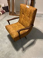 Front angle showing the upholstery and wooden arms