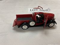 Left side view showing vehicle profile, tailgate down, lot number visible