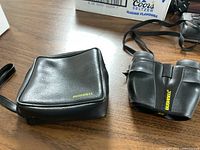 Binoculars with closed case on table