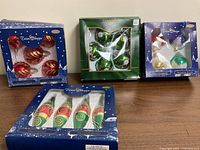 Four boxed ornament sets on table