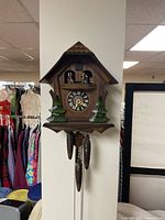 Full view of hanging chalet cuckoo clock on wall