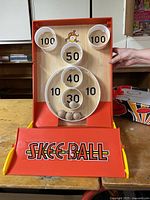 Front view of tabletop Skee-Ball unit showing scoring rings and balls