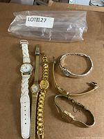 Overview of five wristwatches on table