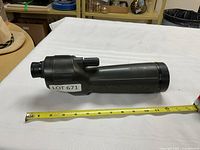 Left side profile of Nikon spotting scope with measuring tape indicating ~12 in length