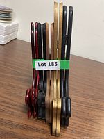 Group of five wooden folding plate stands upright, showing color variety