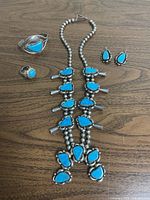 Full set laid out: necklace, bracelet, ring, earrings