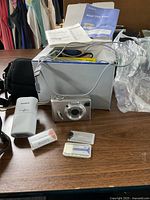 Camera, charger, memory cards, case and box overview