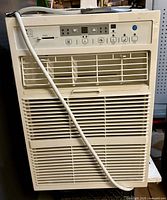 Front view of window air conditioner with control panel and louvers