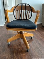 Full view of chair showing design, arms, base, accessories