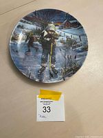 front view of plate showing pond hockey artwork and clips