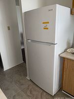 Full view of white Frigidaire top-freezer fridge