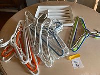 Pile of plastic hangers and utensil tray on table