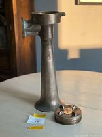 Full view of brass marine horn with end cap beside