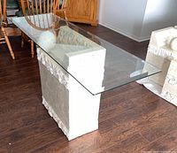 console hall table base with glass top and cube pedestal beside it