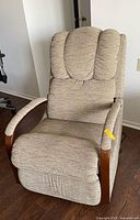 Front view of electric recliner chair showing upholstery and wooden arm accents