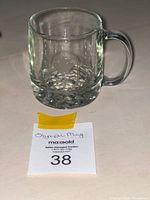 Front view of clear glass mug showing handle and thick base