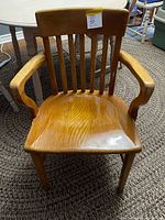 Front view of solid wood armchair showing seat, arms, back slats