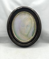 Frontal view of the oil portrait in dark oval wood frame with gilt liner, showing the whole artwork and frame condition.
