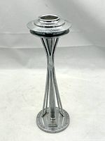 Front view of the chrome Space Needle lighter base showing the structure and circular top insert area