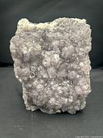 Front view of the amethyst crystal cluster showing dense violet quartz points and overall texture.