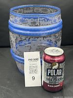 Front view of barrel-form Bohemian glass punch bowl with cobalt blue bands and rococo etched hunting scenes. Includes a can for size reference.