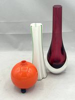 All three glass vases placed together on a white background highlighting their size and colors.