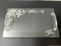 Full view of rectangular glass serving tray with etched orchid designs and two clear Lucite handles, showing overall condition and design details.