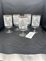 Set of five vintage Cera Glass Camelot series goblets arranged on black cloth background showing overall size and condition.