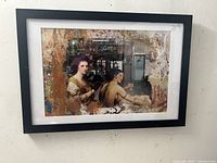 Full view of the framed archival print showing two tattooed classical figures and urban layered background.