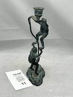 Front and angled view of verdigris bronzed brass frog candlestick with two sculpted frogs on a vine, showing the verdigris patina and candle cup at the top.