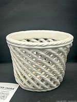 Front angle showing the white ceramic rope detail basketweave open design planter