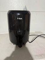 Photo of the T-Fal air fryer showing the closed unit with the logo visible and power cord at the back.