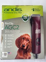 Box of Andis ProClip AGC2 dog clipper with photo of dog on front and product features listed
