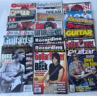Top-view photo showing various guitar and music magazines laid out overlapping including Guitar World, Guitar Techniques, and Guitar Player with covers featuring musicians Jeff Beck, Edward Van Halen, Dire Straits, and others.